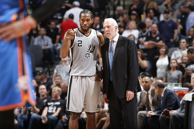 Kawhi Leonard #2 speaks with head coach, Gregg Popovich of the San Antonio Spurs during the game against the Oklahoma City Thunder.