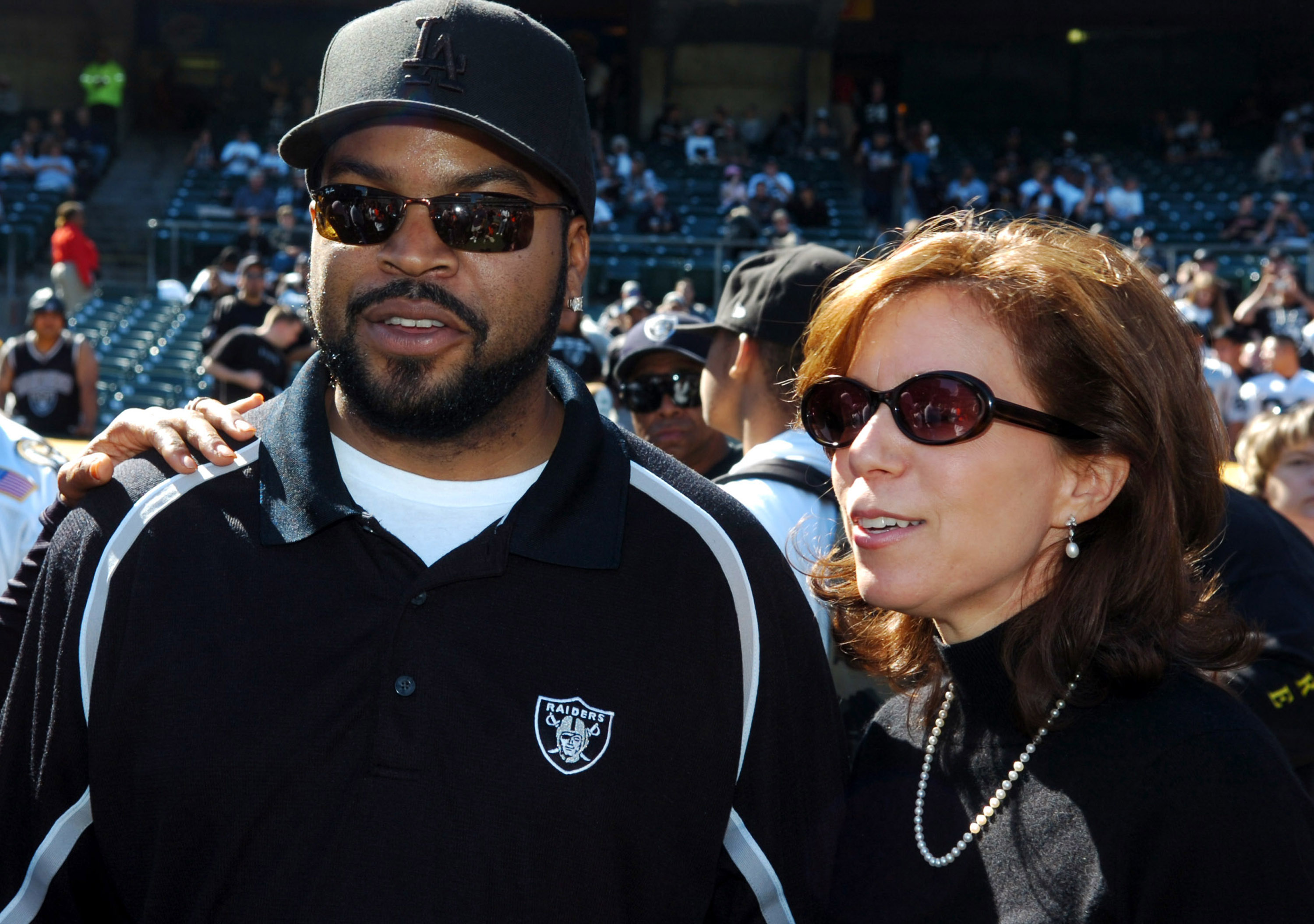 Ice Cube aka O'Shea Jackson poses with Oakland Raider CEO Amy Trask before game against the San Diego Chargers at McAfee Coliseum on Sunday, October 16, 2005. (Photo by Kirby Lee/NFLPhotoLibrary)