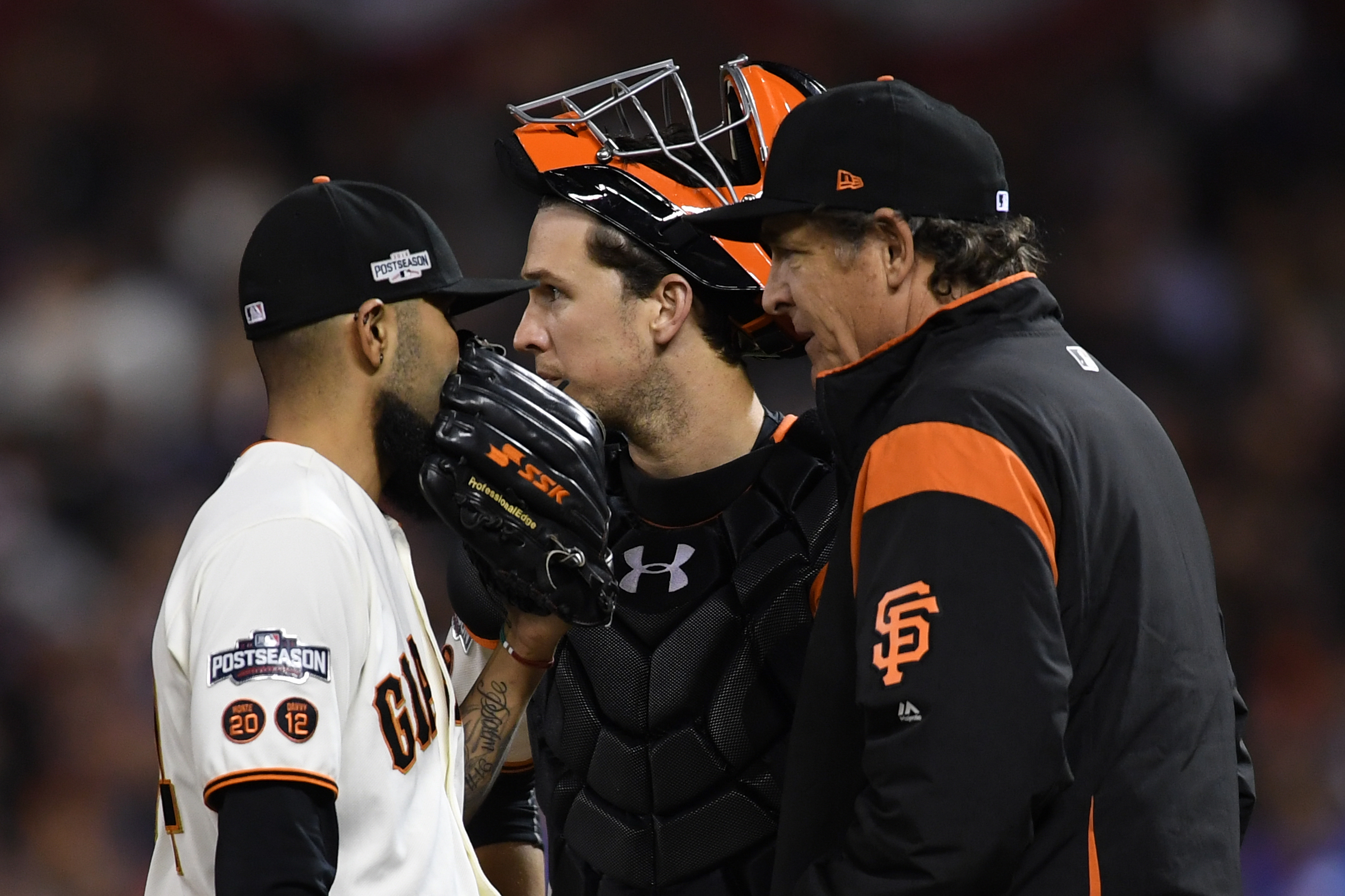 SAN FRANCISCO, CA - OCTOBER 11: Sergio Romo #54, Buster Posey #28 and Dave Righetti #19 of the San Francisco Giants confer on the mound in the ninth inning of Game Four of their National League Division Series against the Chicago Cubs at AT&T Park on October 11, 2016 in San Francisco, California.