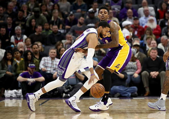 SACRAMENTO, CA - DECEMBER 12:  Garrett Temple #17 of the Sacramento Kings drives on Nick Young #0 of the Los Angeles Lakers at Golden 1 Center on December 12, 2016 in Sacramento, California.  NOTE TO USER: User expressly acknowledges and agrees that, by downloading and or using this photograph, User is consenting to the terms and conditions of the Getty Images License Agreement.  