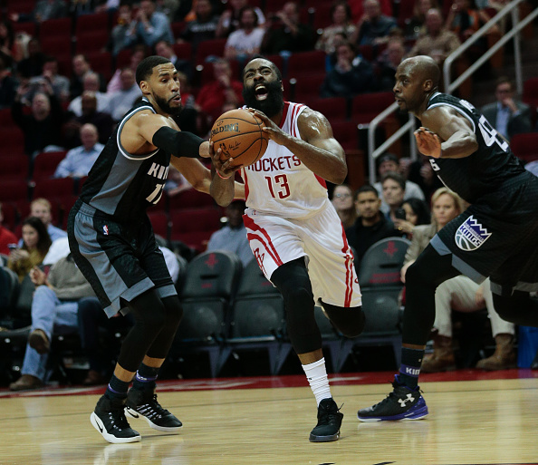 HOUSTON, TX - DECEMBER 14:  James Harden #13 of the Houston Rockets drives between Garrett Temple #17 of the Sacramento Kings and Anthony Tolliver #43 at Toyota Center on December 14, 2016 in Houston, Texas. NOTE TO USER: User expressly acknowledges and agrees that, by downloading and/or using this photograph, user is consenting to the terms and conditions of the Getty Images License Agreement.  (Photo by Bob Levey/Getty Images)