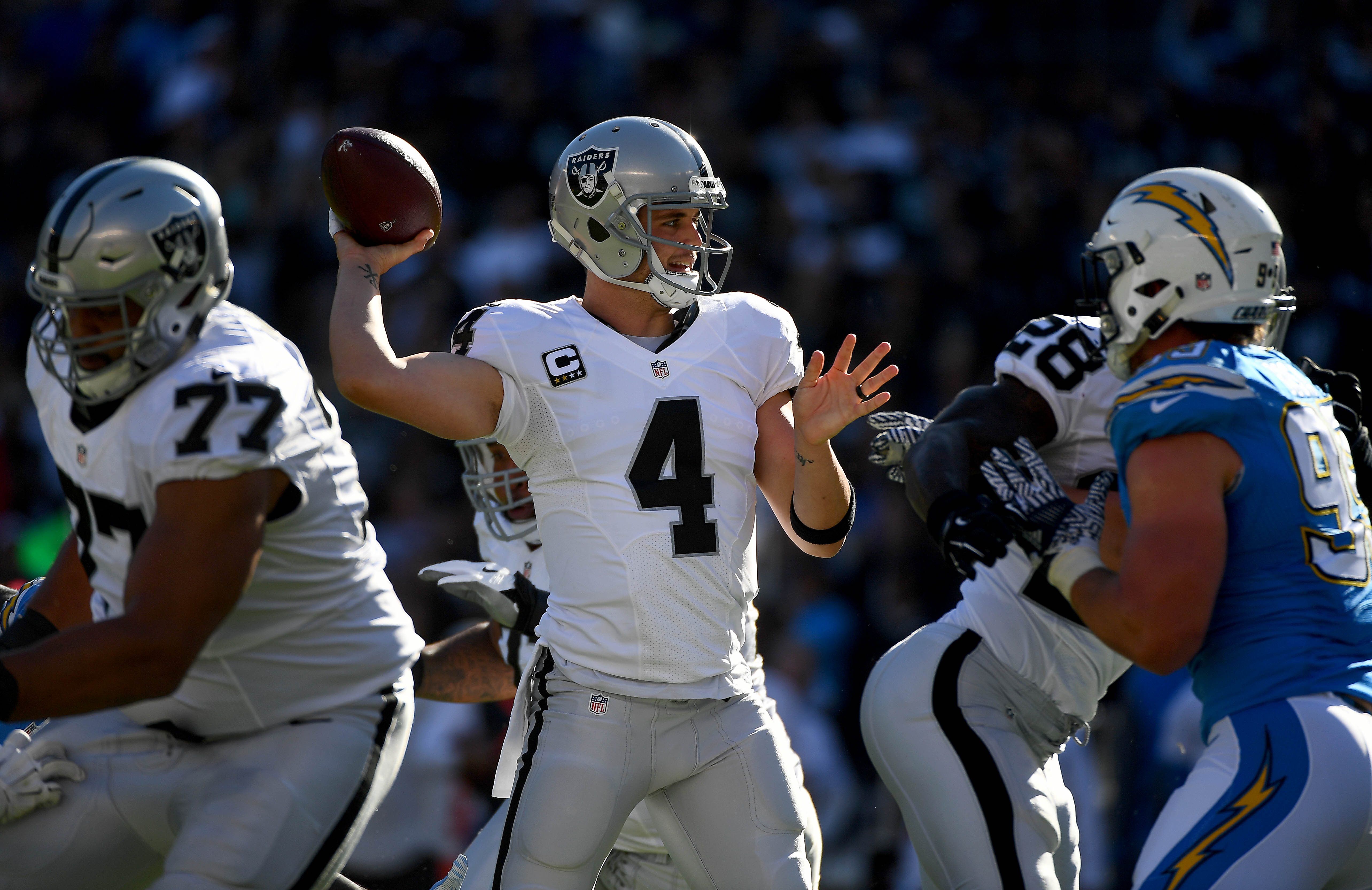 SAN DIEGO, CA - DECEMBER 18:  Quarterback Derek Carr #4 of the Oakland Raiders throws from the pocket during his team\'s game against the San Diego Chargers at Qualcomm Stadium on December 18, 2016 in San Diego, California. (Photo by Donald Miralle/Getty Images)