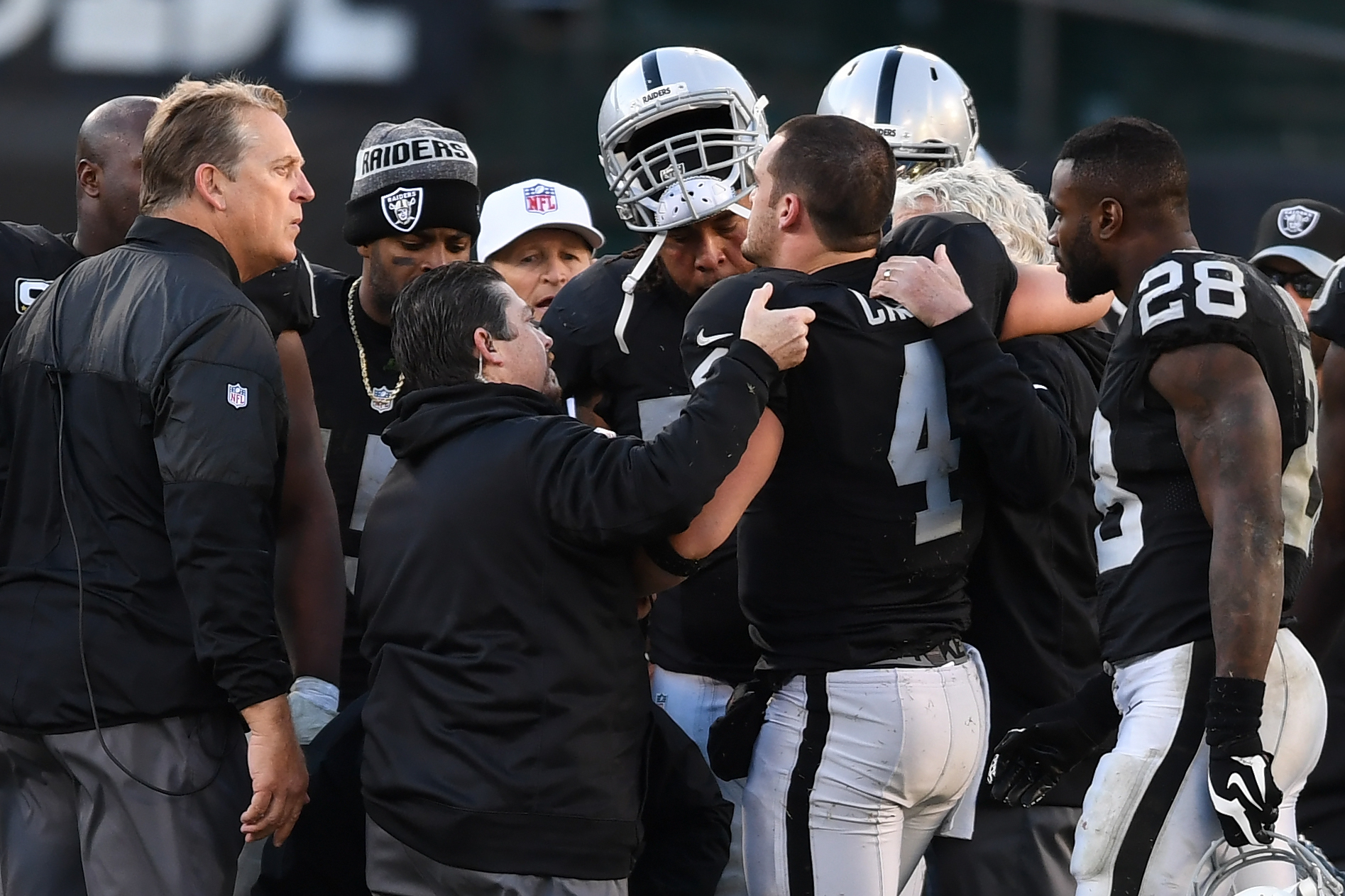 OAKLAND, CA - DECEMBER 24:  Derek Carr #4 of the Oakland Raiders is helped off the field after injuring his right leg during their NFL game against the Indianapolis Colts at Oakland Alameda Coliseum on December 24, 2016 in Oakland, California.  (Photo by Thearon W. Henderson/Getty Images)