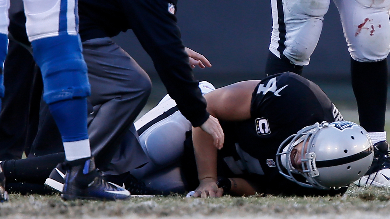 OAKLAND, CA - DECEMBER 24:  Derek Carr #4 of the Oakland Raiders lays on the field after injuring his right leg during their NFL game against the Indianapolis Colts at Oakland Alameda Coliseum on December 24, 2016 in Oakland, California.  (Photo by Brian Bahr/Getty Images)