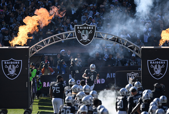 OAKLAND, CA - DECEMBER 24: Derek Carr #4 and the Oakland Raiders runs onton the field prior to playing the Indianapolis Colts in an NFL football game at the Oakland-Alameda County Coliseum on December 24, 2016 in Oakland, California. (Photo by Thearon W. Henderson/Getty Images)