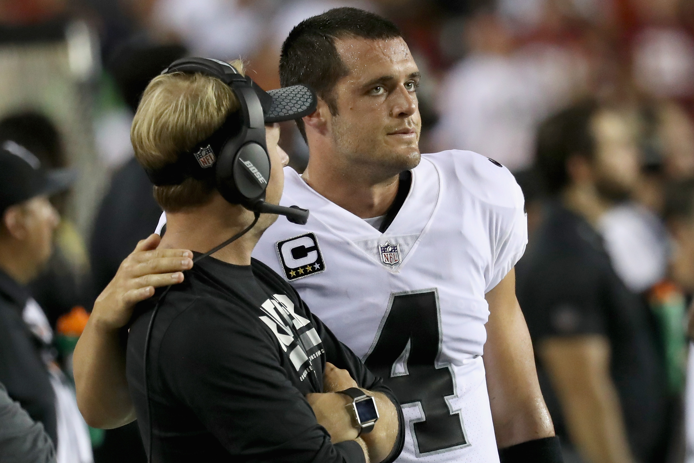 LANDOVER, MD - SEPTEMBER 24: Quarterback Derek Carr #4 of the Oakland Raiders talks with wide recievers coach Nick Holz during the closing moments of the Raiders 27-10 loss to the Washington Redskins at FedExField on September 24, 2017 in Landover, Maryland.