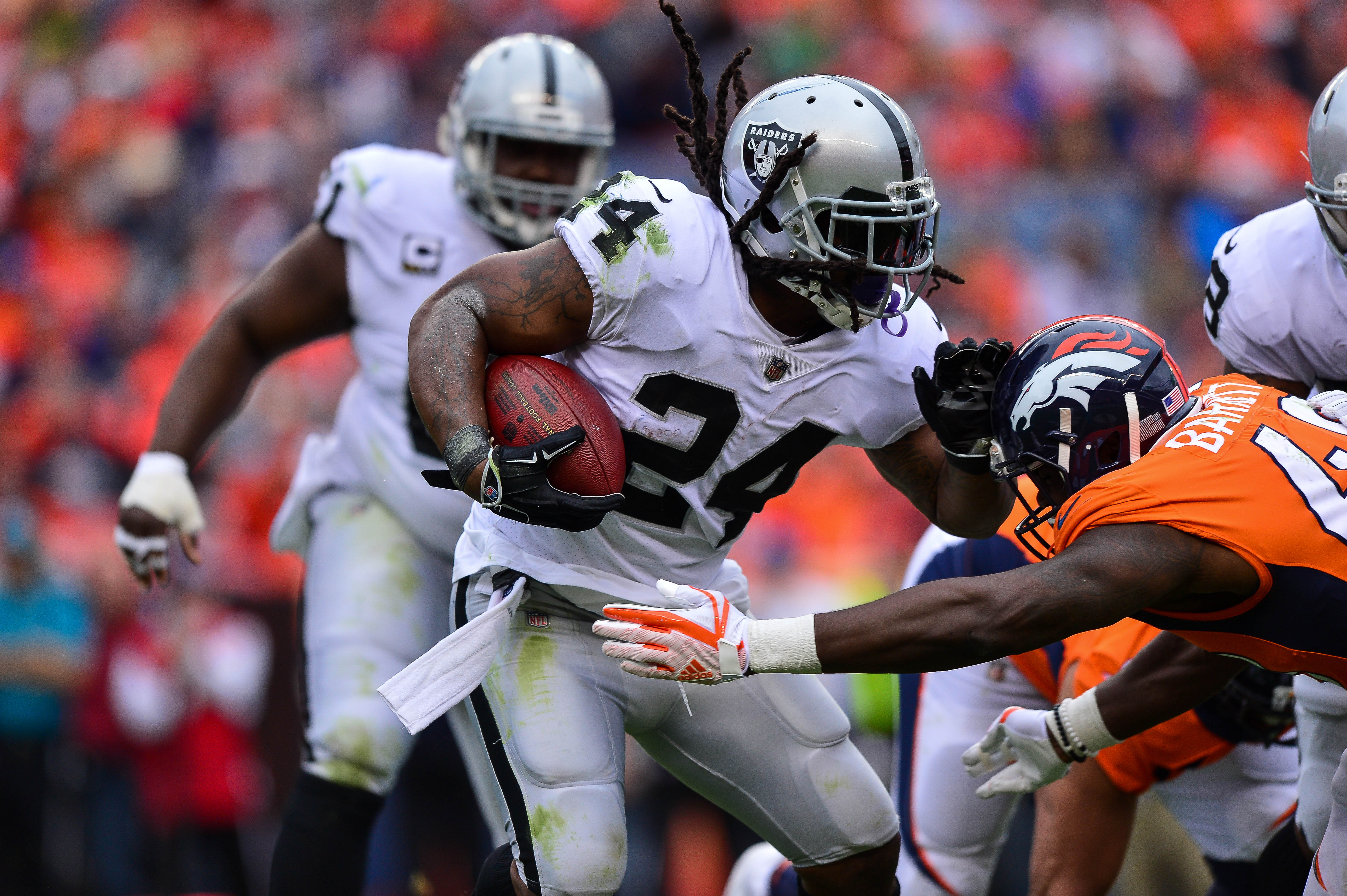 DENVER, CO - OCTOBER 1: Running back Marshawn Lynch #24 of the Oakland Raiders rushes against the Denver Broncos int he first quarter of a game at Sports Authority Field at Mile High on October 1, 2017 in Denver, Colorado.